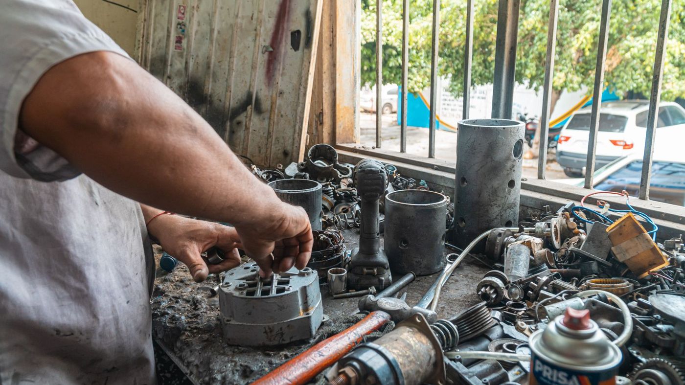 Mechanic working on engine parts in an auto repair shop