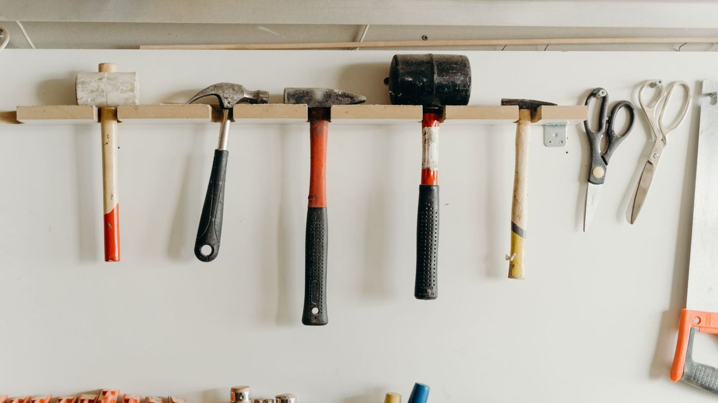Hand tools hanging on a wall in a hardware workshop
